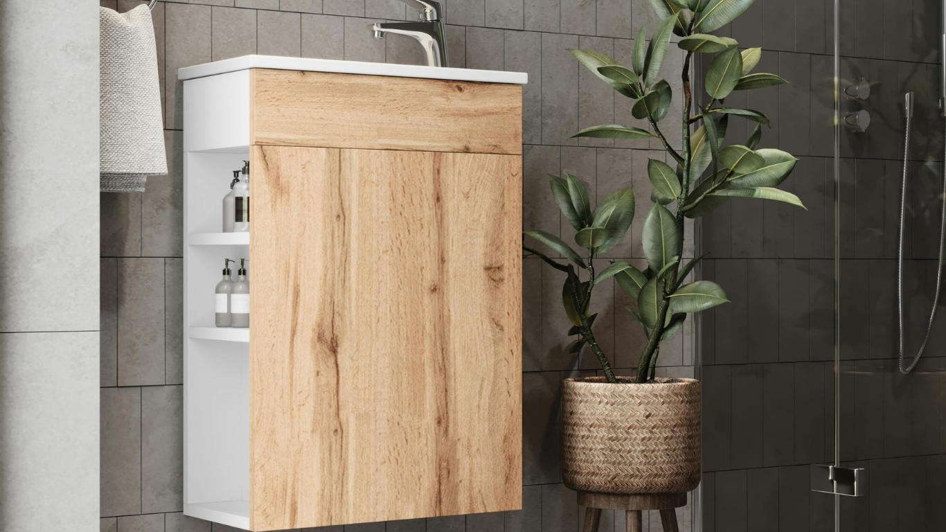 Bathroom vanity with wood-grain front, white side with shelving, and a plant next to it.