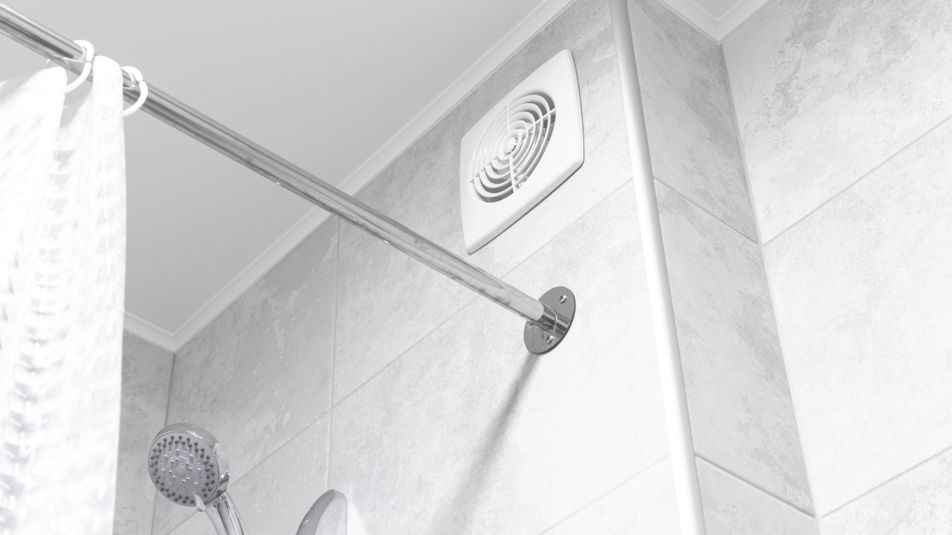 Shower with a ceiling vent, shower head, and towel on a rod, all in grayscale.