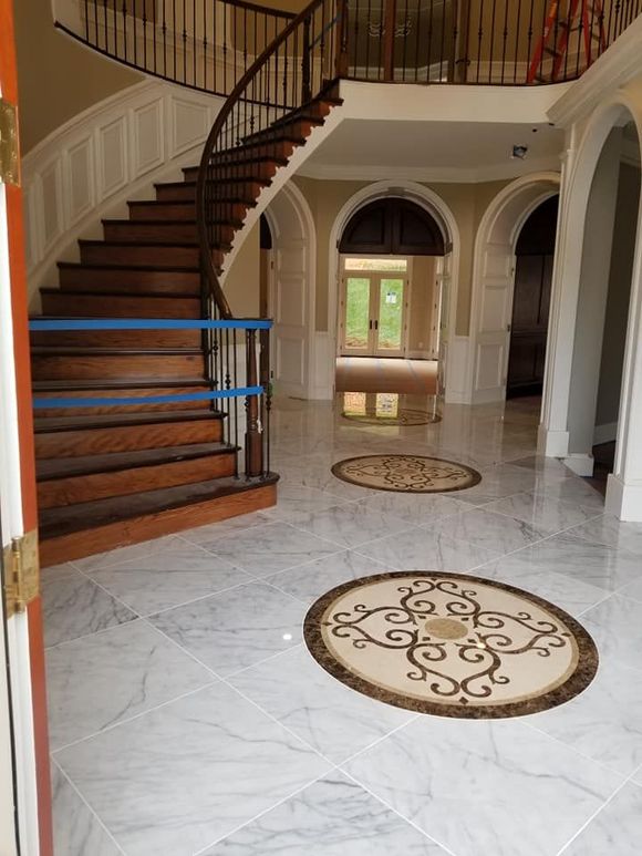 A staircase with a circular design on the floor