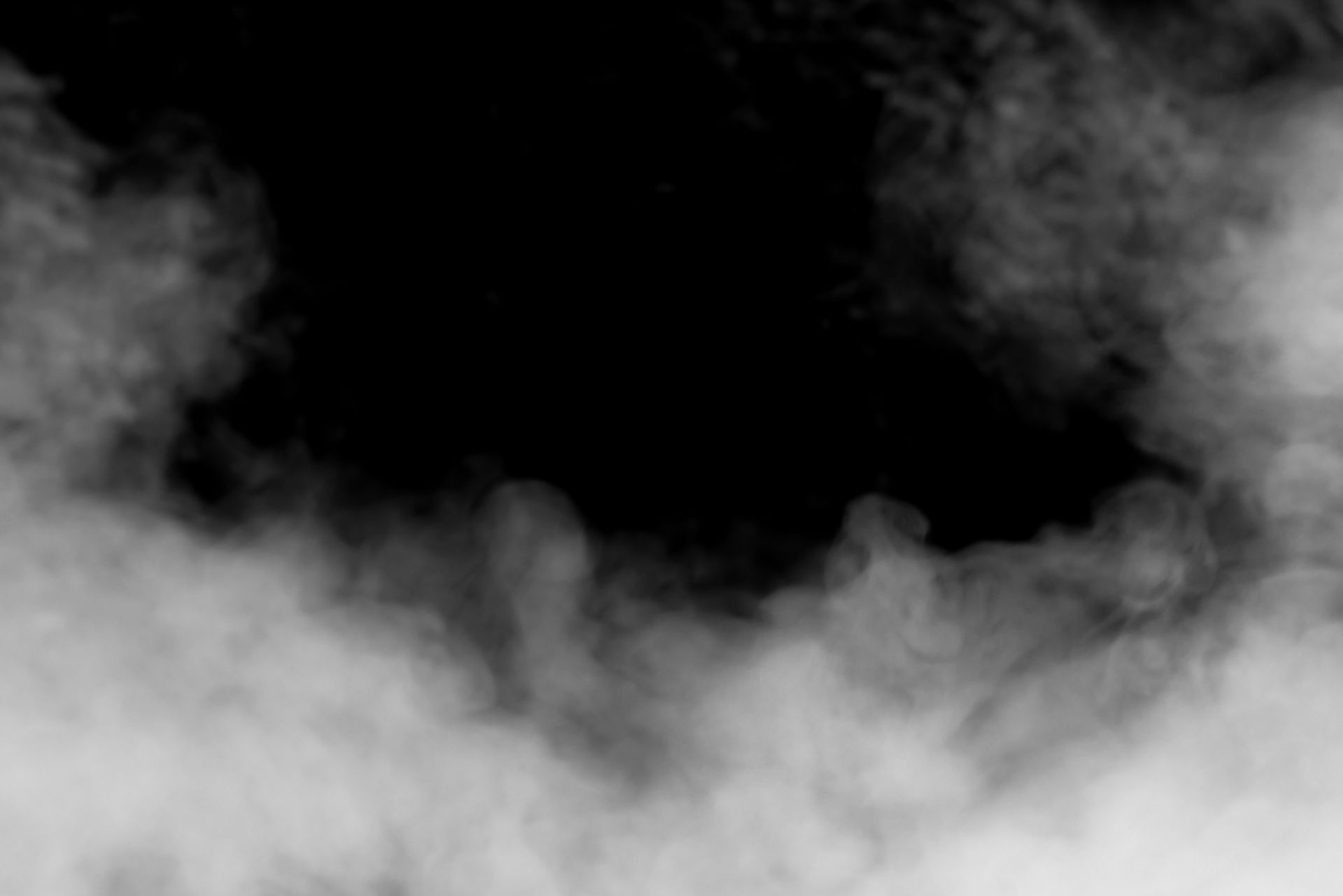 A black and white photo of smoke on a black background.