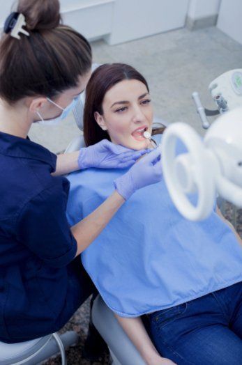 Female patient getting a dental cleaning at our Brooklyn office.