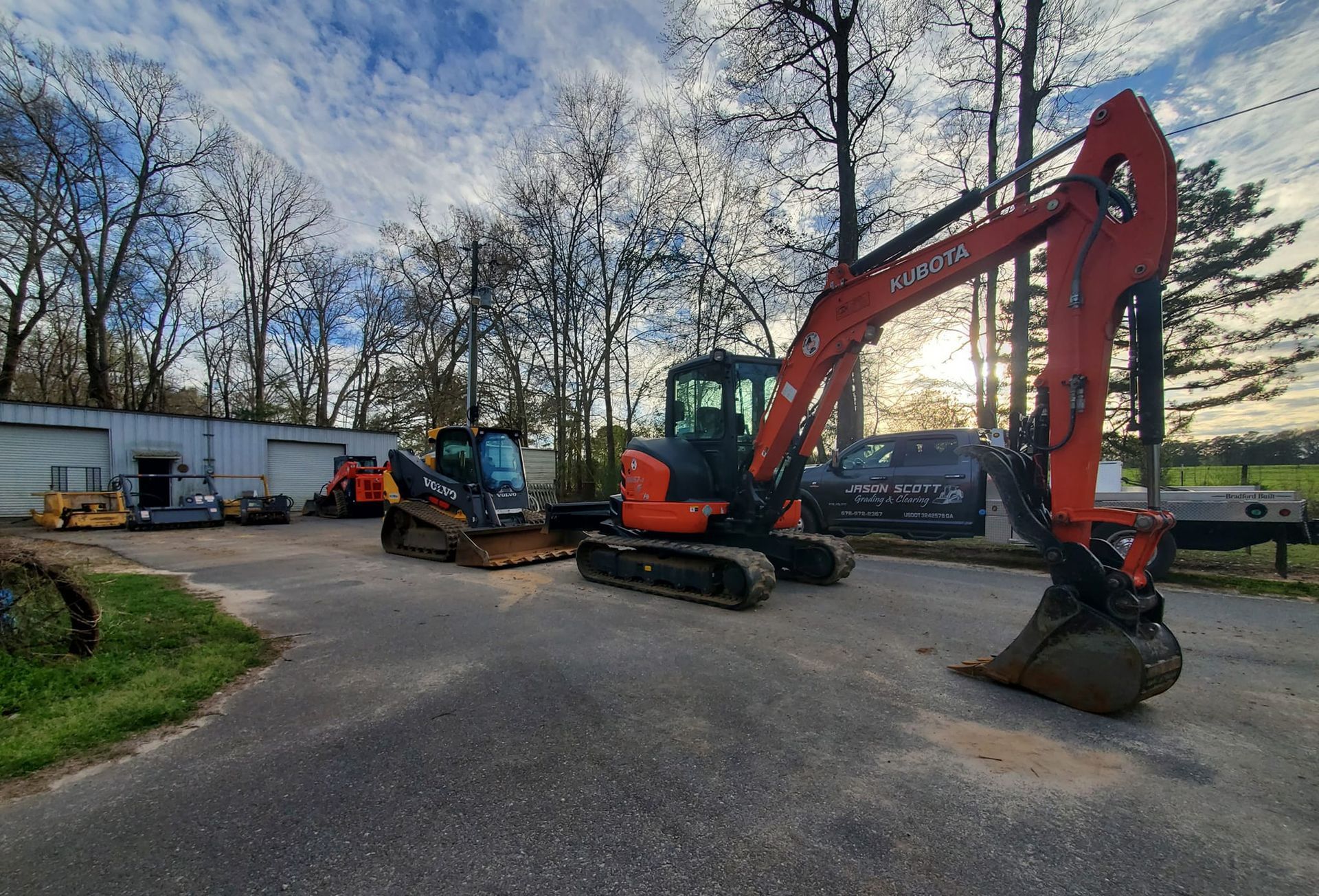 A couple of excavators are parked on the side of the road.