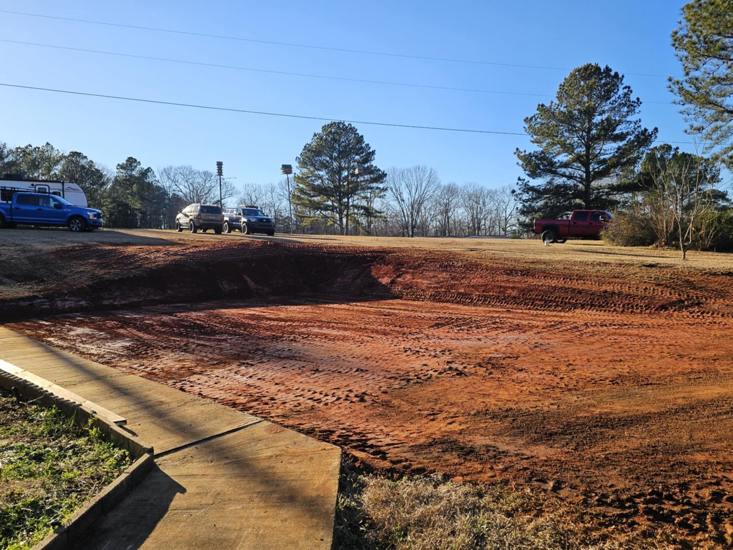 A man wearing a mask is carrying a cardboard box into a van.