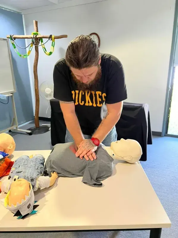 Young Guy Teaching CPR using Doll - First Aid in Mackay, QLD