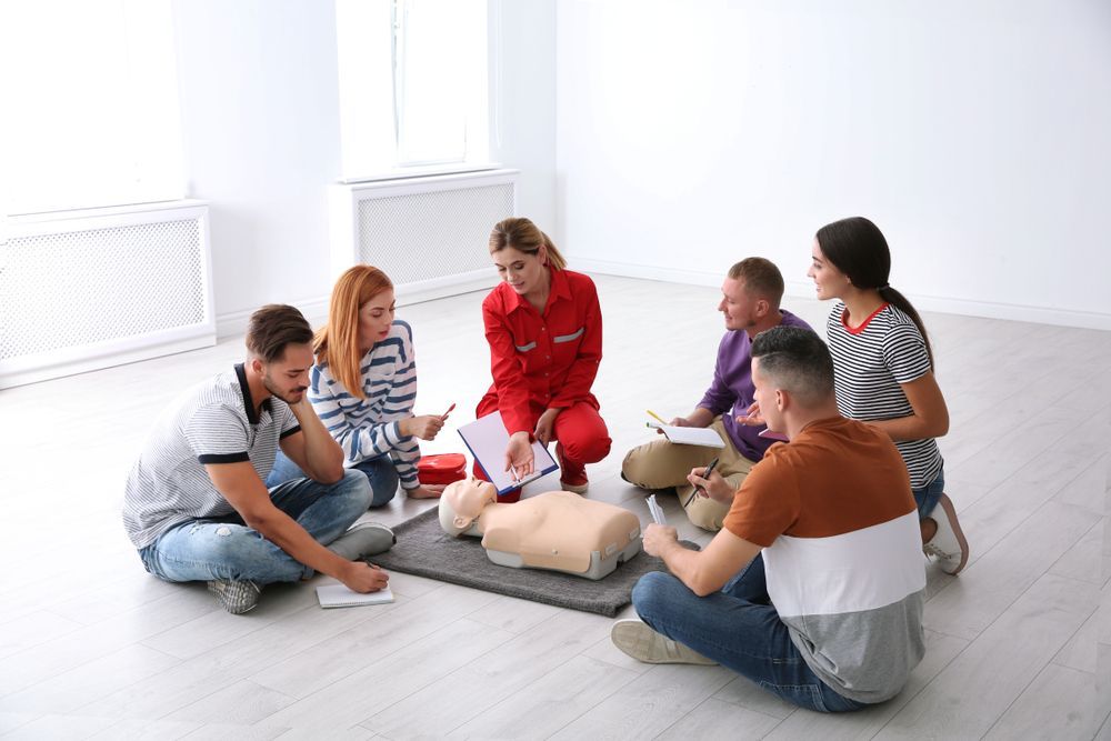 Group of People with Instructor at First Aid Class Indoors - First Aid in Mackay, QLD