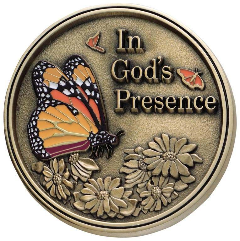 A coin with a butterfly and the words in god 's presence