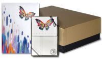 A box with a notebook and a card with butterflies on them.