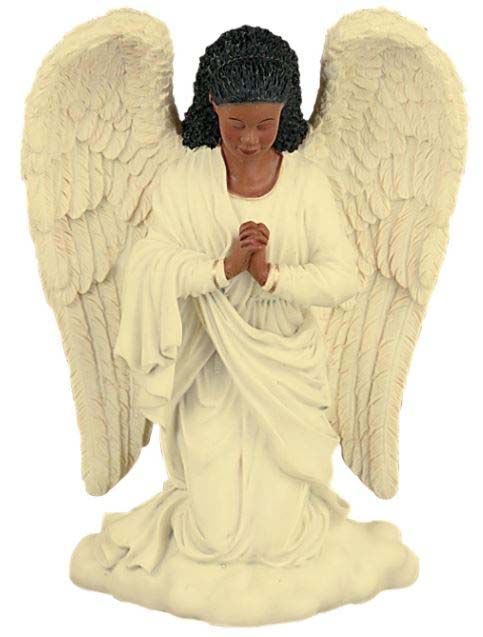 A statue of an angel is kneeling down and praying