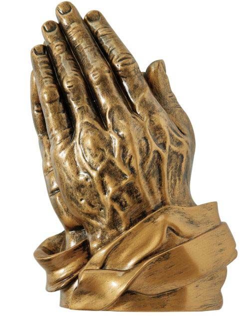 A statue of praying hands on a white background
