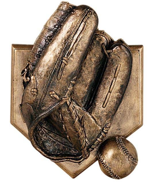 A statue of a baseball glove and ball on a base