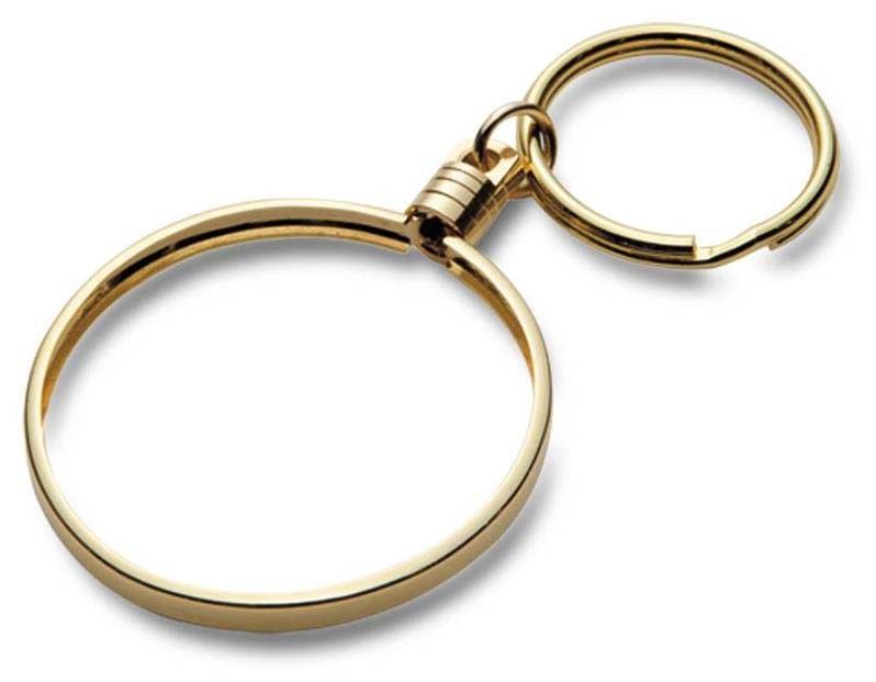 A close up of a gold key chain on a white background