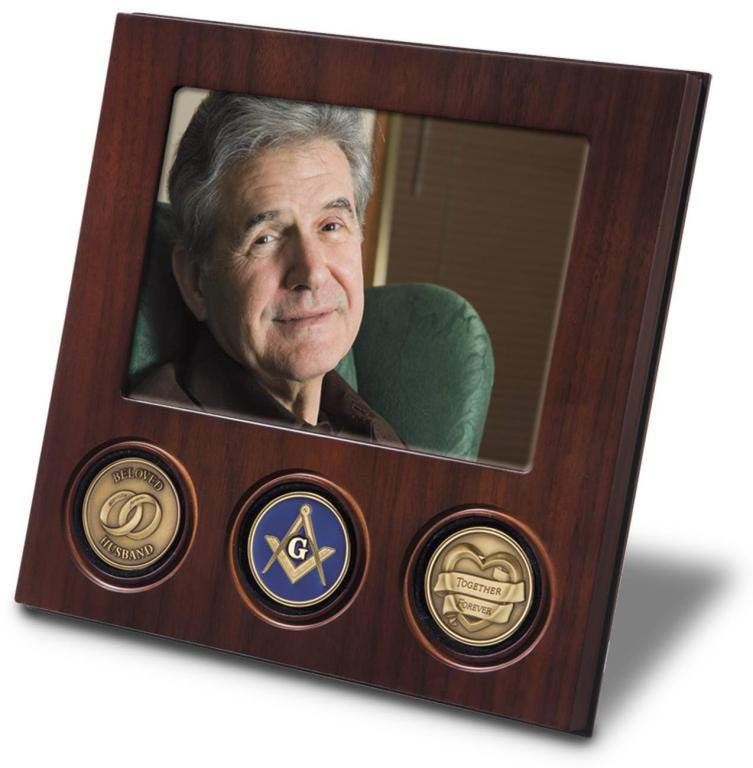 A picture frame with a masonic symbol on it