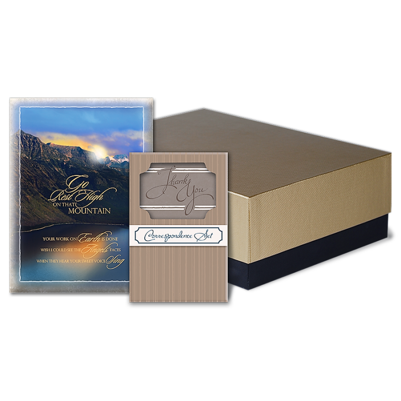 A box filled with cards and a picture of a mountain.