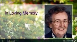 A video of an elderly woman with glasses and the words `` in loving memory ''.