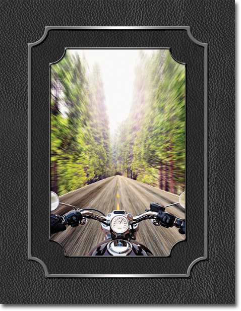 A picture of a person riding a motorcycle down a road.