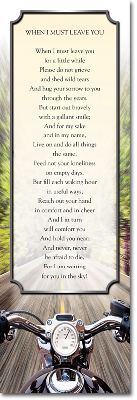 A person is riding a motorcycle down a road.