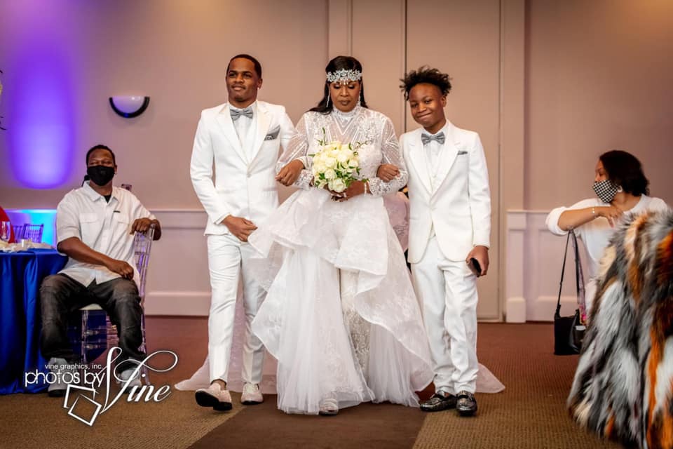 A bride and groom are walking down the aisle at their wedding.