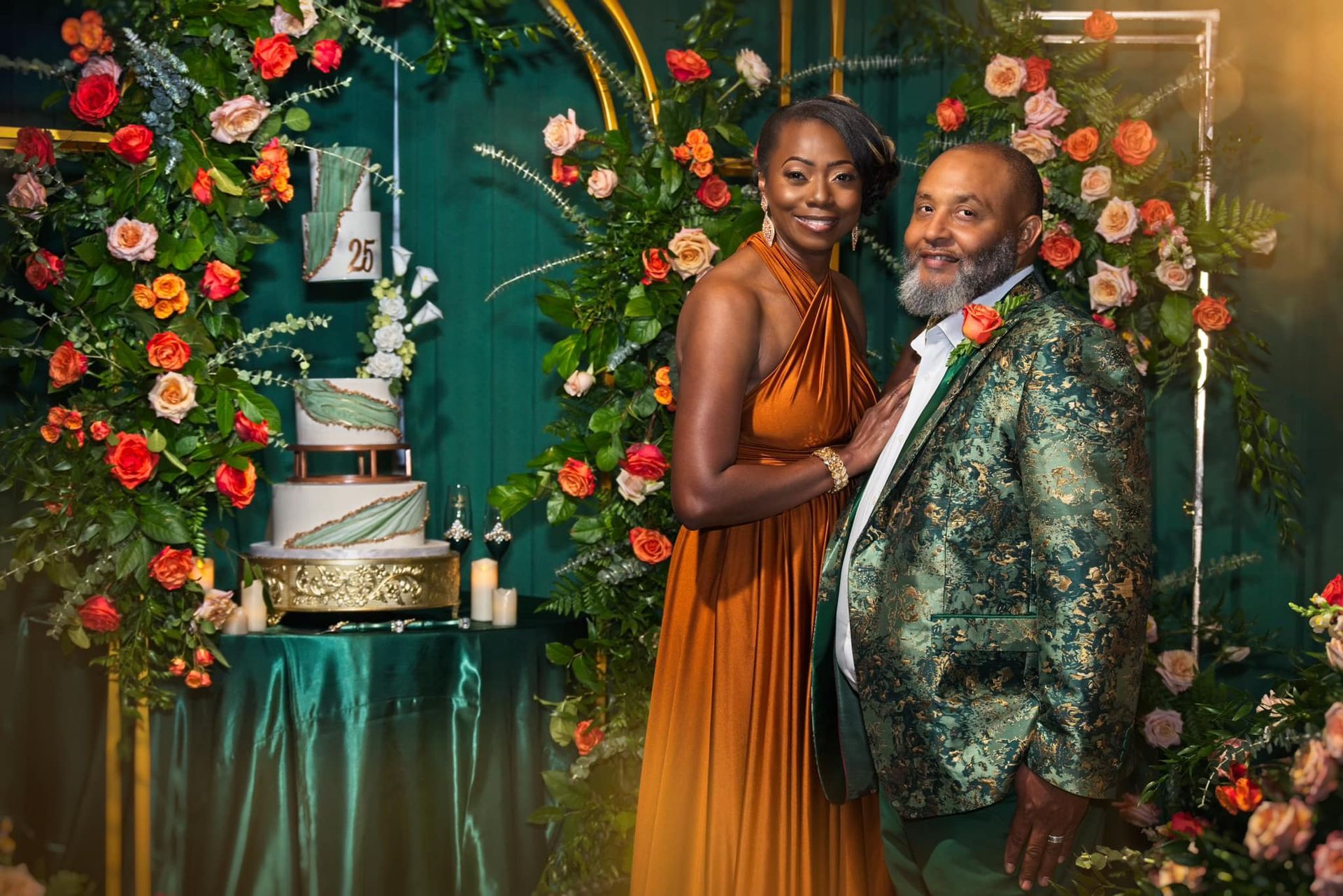 A man and a woman are posing for a picture in front of a wedding cake.