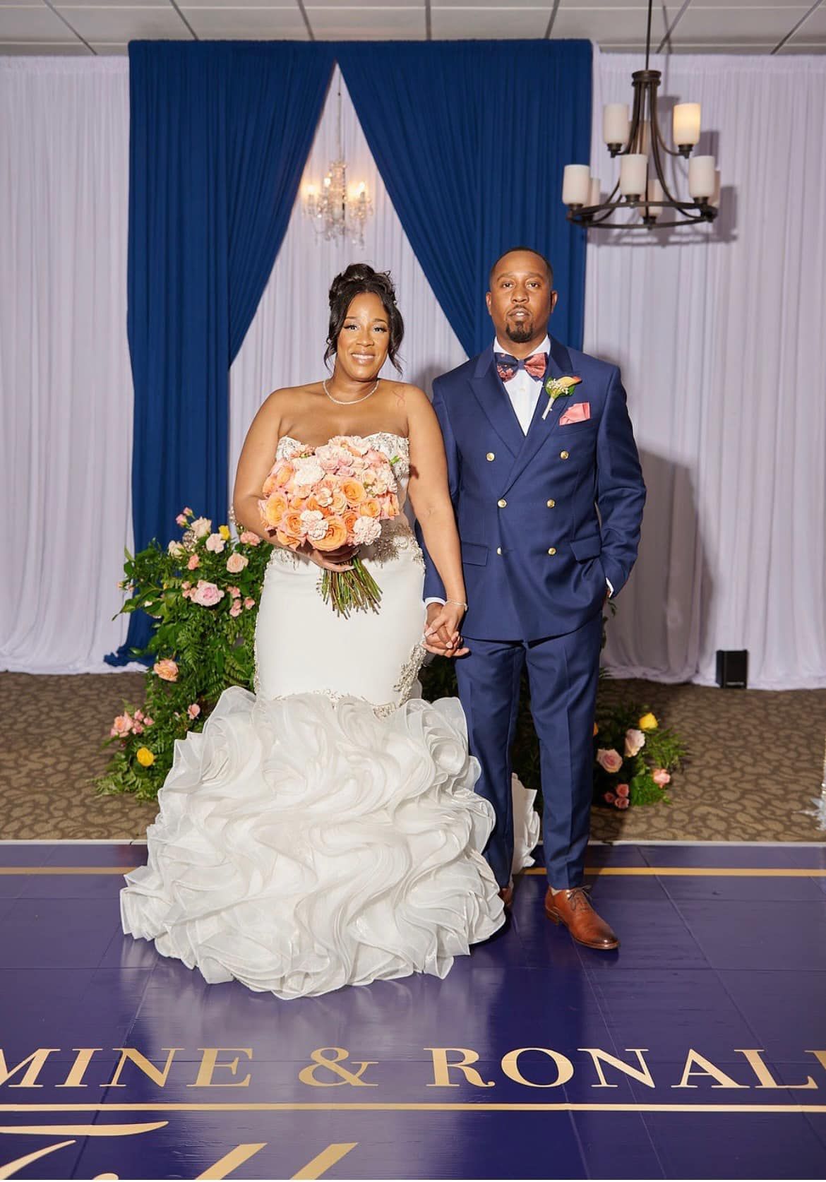 A bride and groom are posing for a picture on their wedding day.