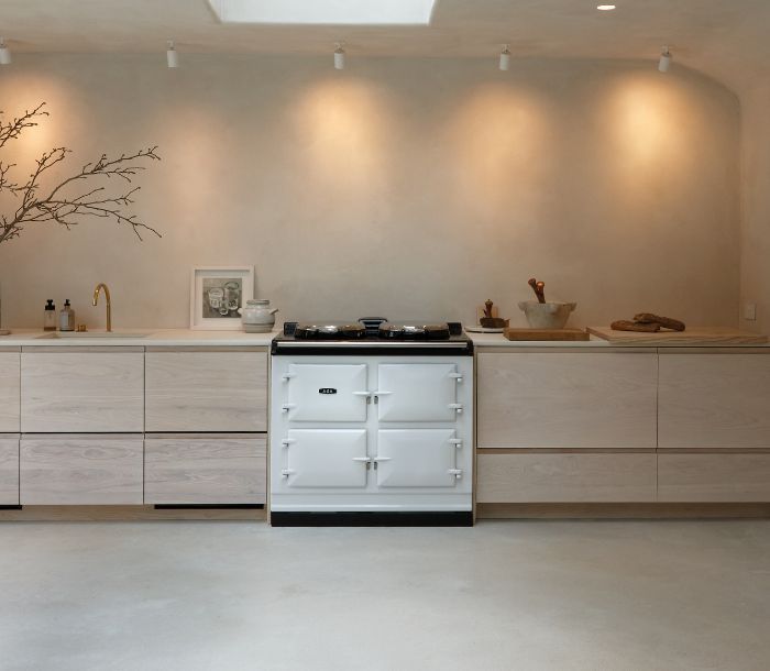 Photograph of white AGA range cooker installed in a modern kitchen.