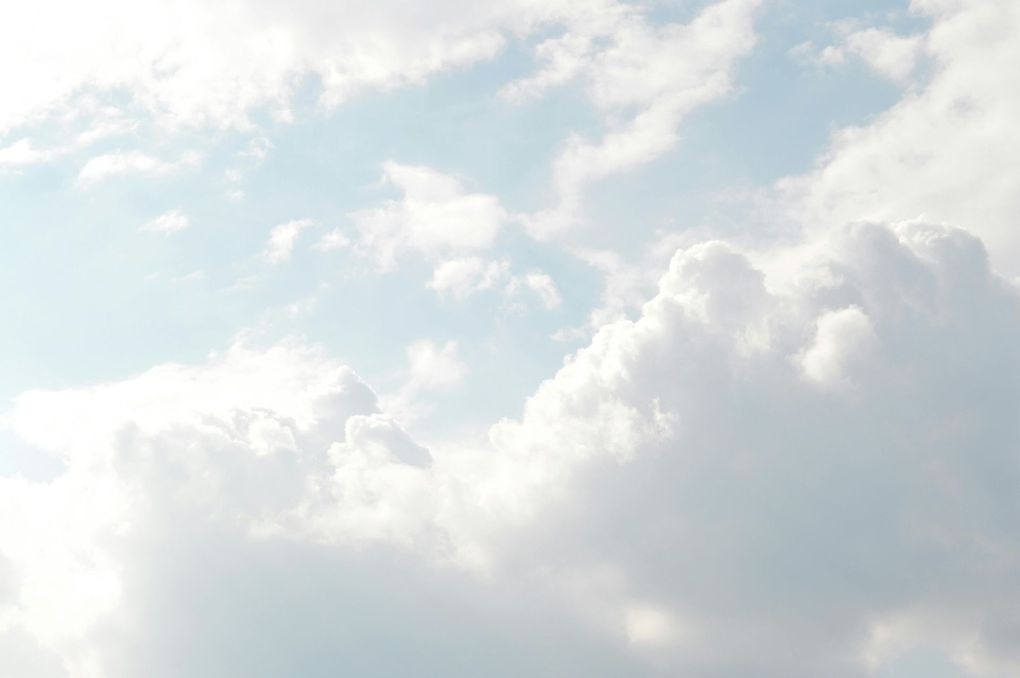 A blue sky with white clouds in it