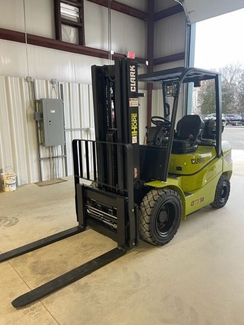 A yellow and black Clark forklift in a warehouse.
