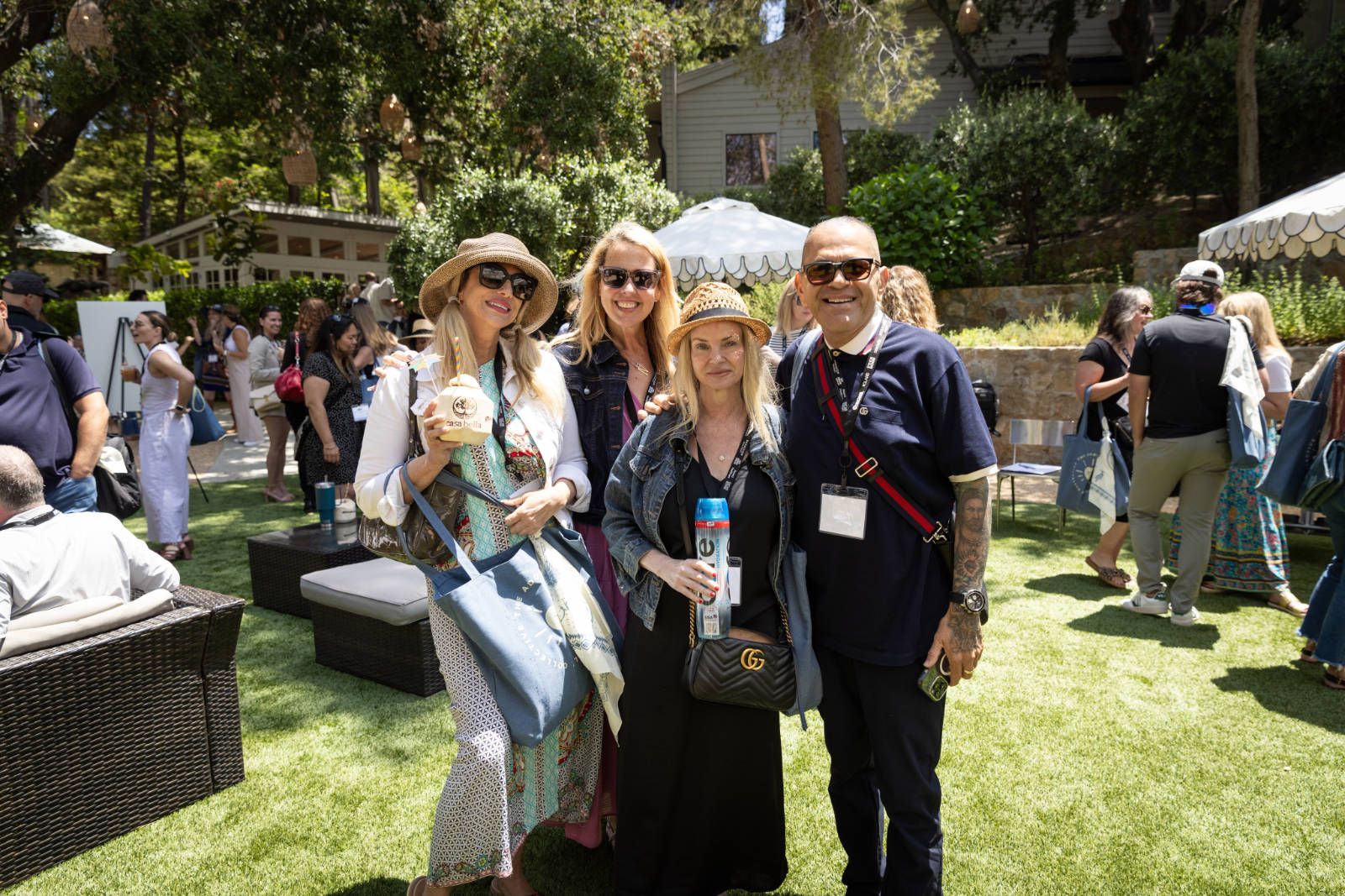 A group of people are posing for a picture in a grassy field.