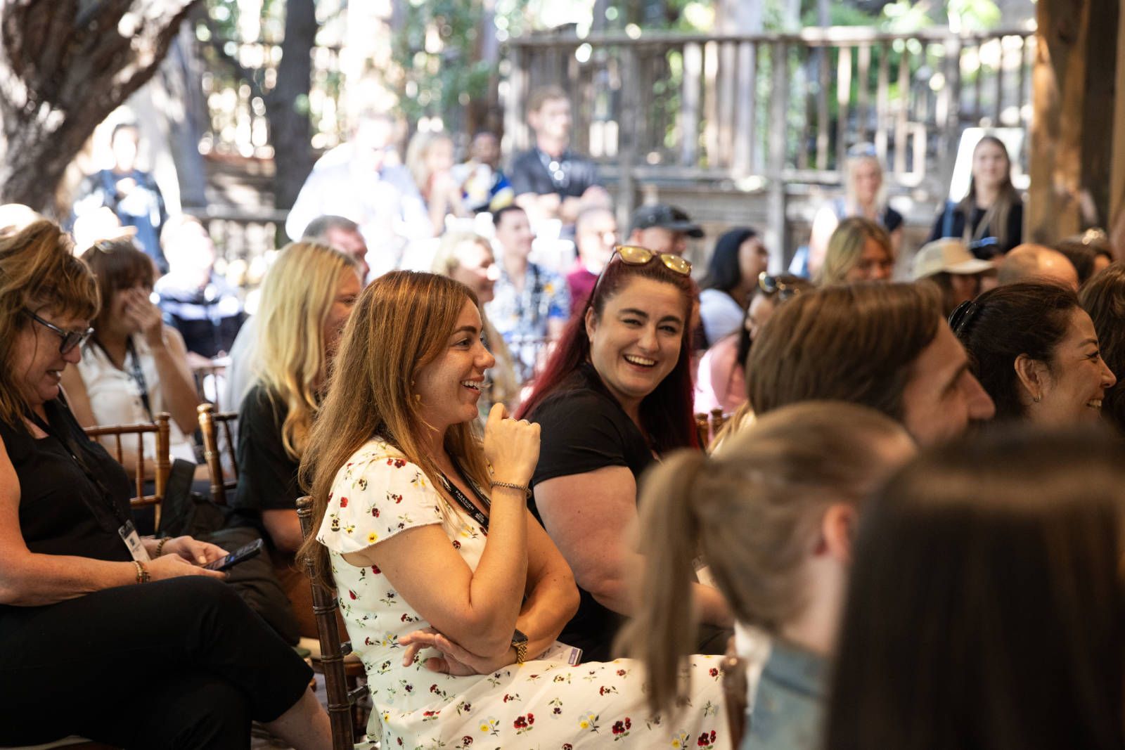 A group of people are sitting in chairs watching a presentation.