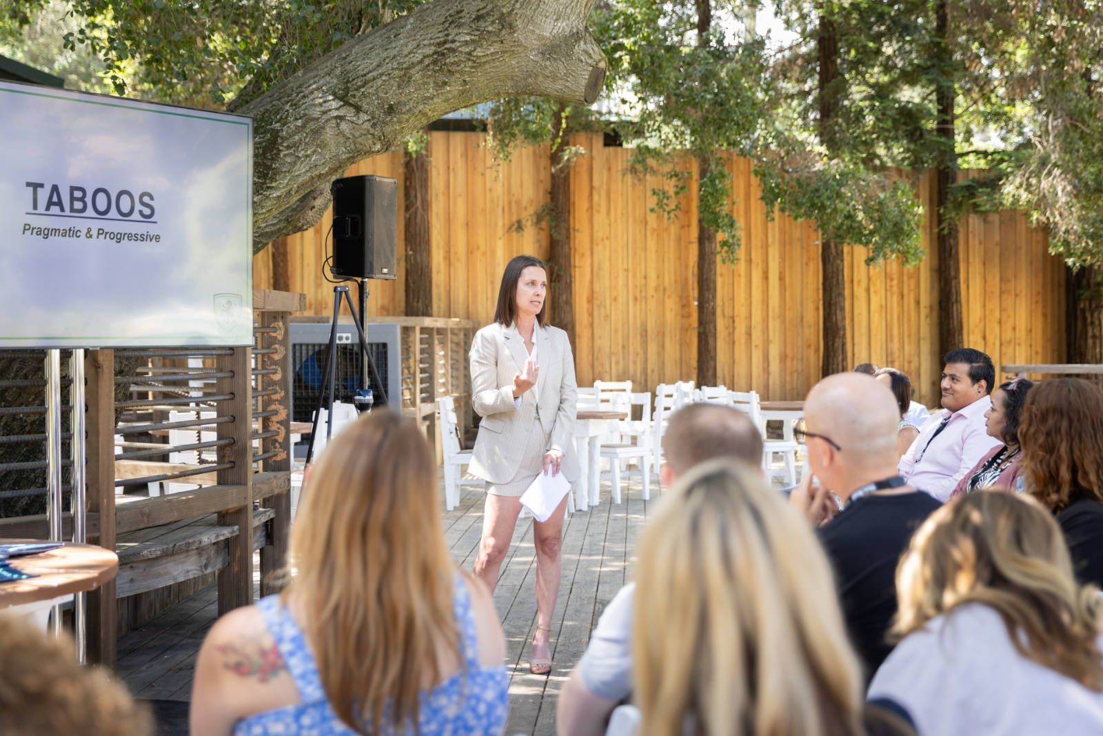 A woman is giving a presentation to a group of people.