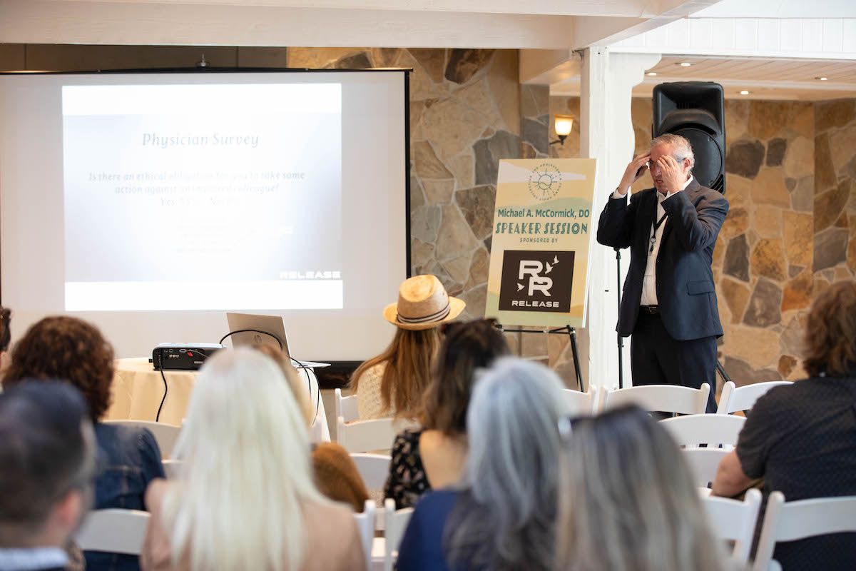 A man is giving a presentation to a group of people sitting in chairs.