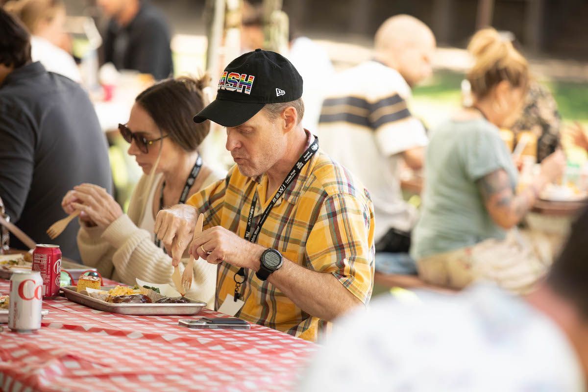 A group of people are sitting at a table eating food.