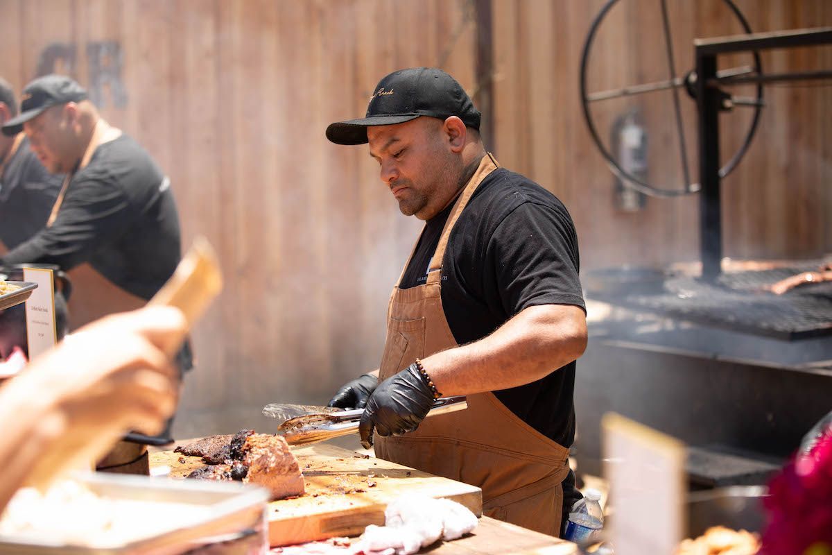 A man in an apron is cooking food in a restaurant.