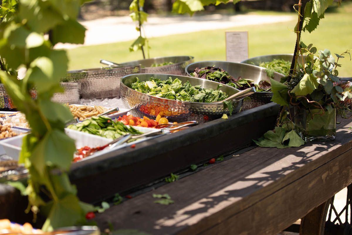 A wooden table topped with a variety of food.