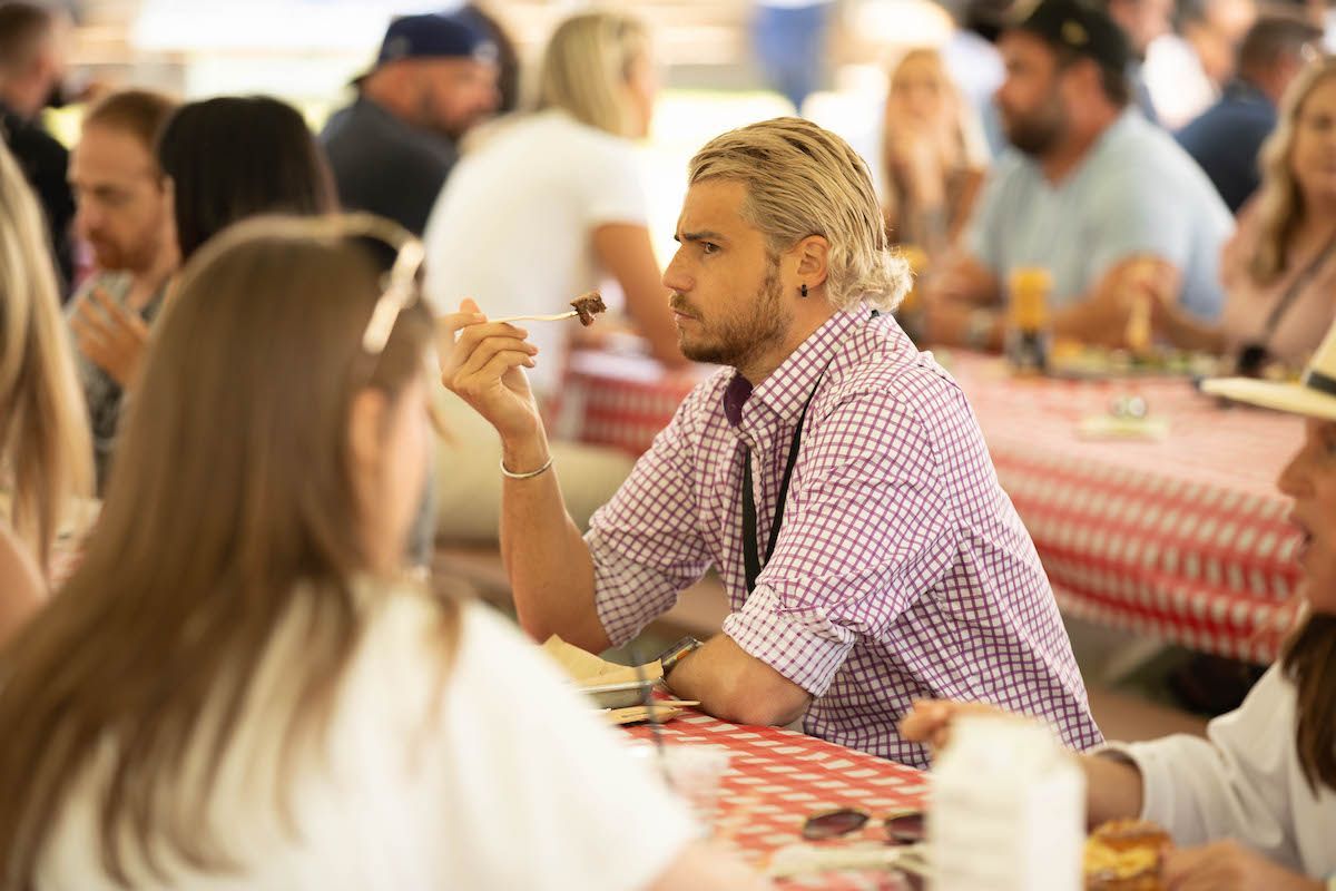 A group of people are sitting at a table eating food.