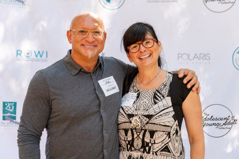 A man and a woman are posing for a picture.