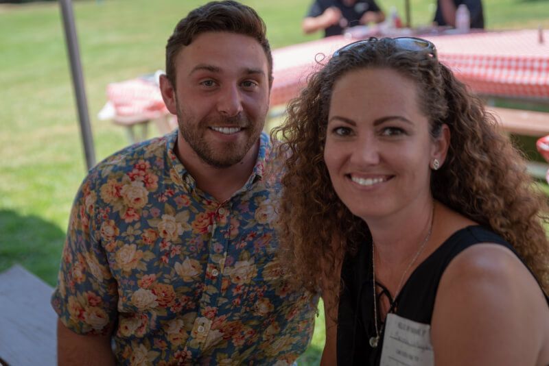 A man and a woman are sitting next to each other and smiling for the camera.