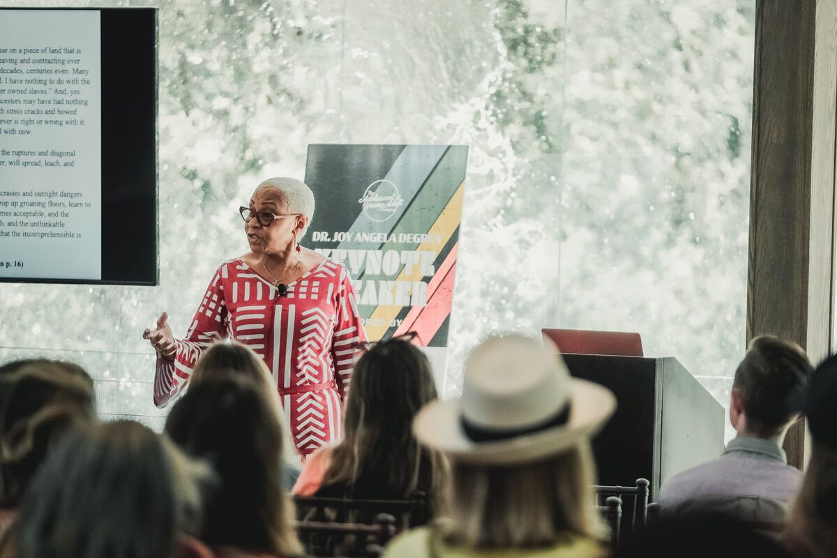A woman is giving a presentation to a group of people.