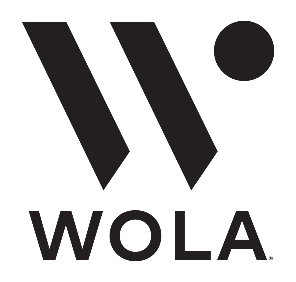 Black logo for WOLA featuring a stylized "W" topped with a dot, with the text "WOLA" underneath in a clean, sans-serif font.