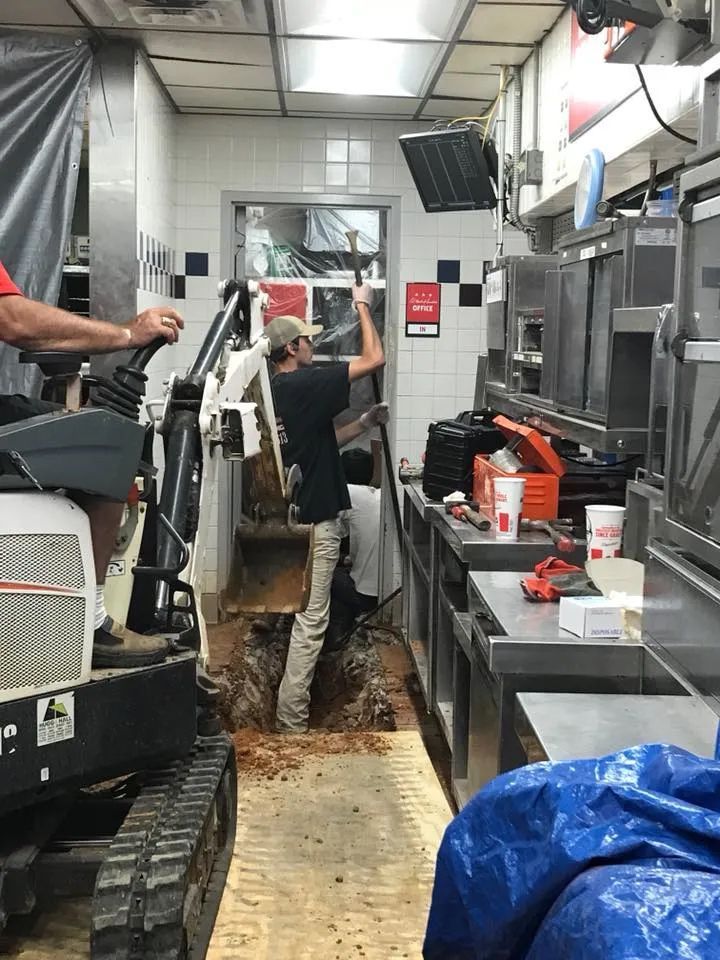 Mini Excavator Digging the Floor of Commercial Kitchen