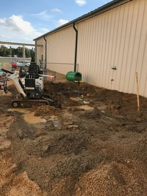 Mini Excavator Digging in a Backyard