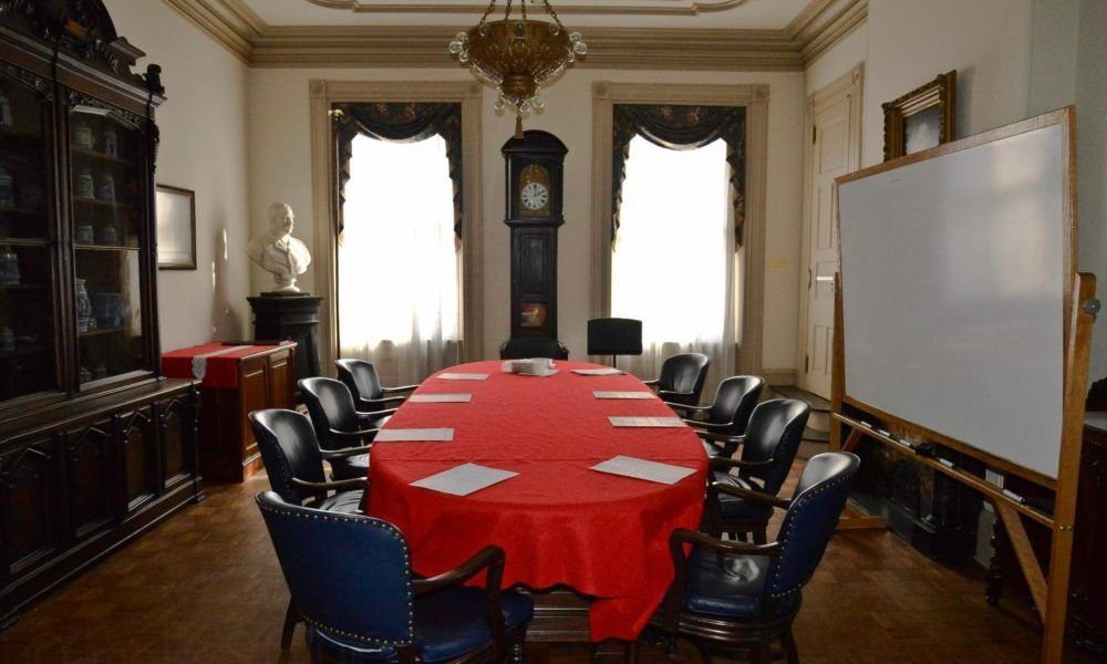 A conference room with a long table and chairs