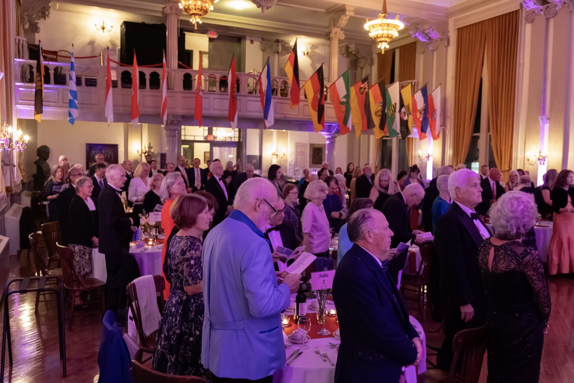 A large group of people are sitting at tables in a large room.
