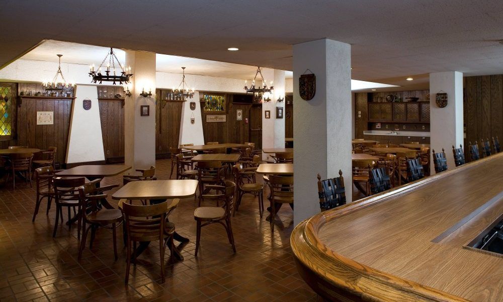 A restaurant with tables and chairs and a bar