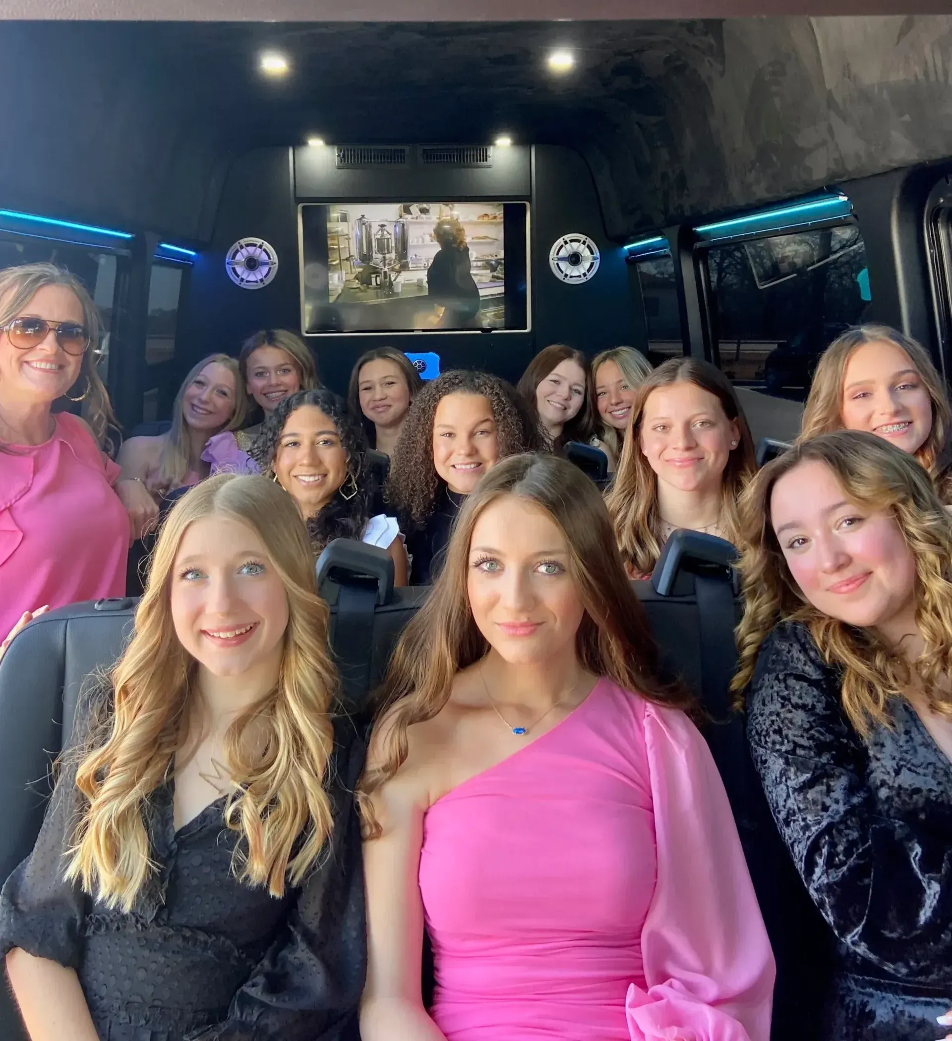 A group of women are posing for a picture in a van.