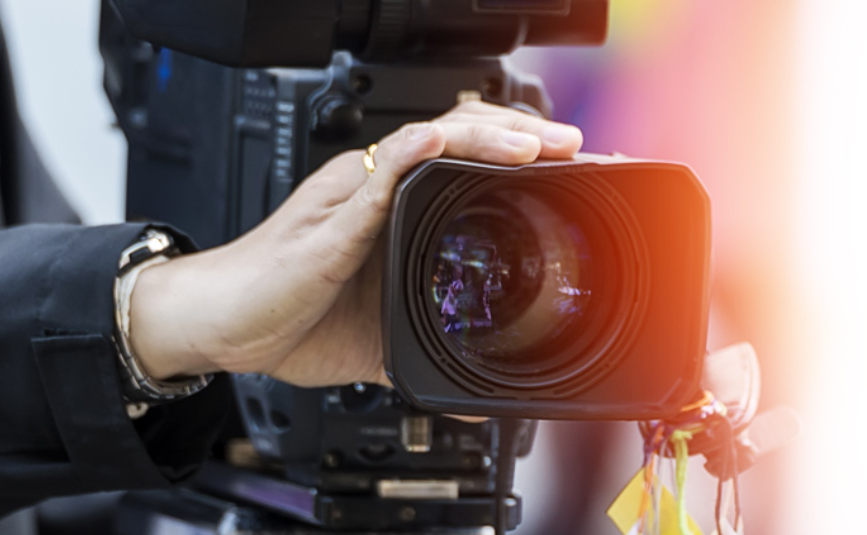 A person is holding a video camera in their hand.