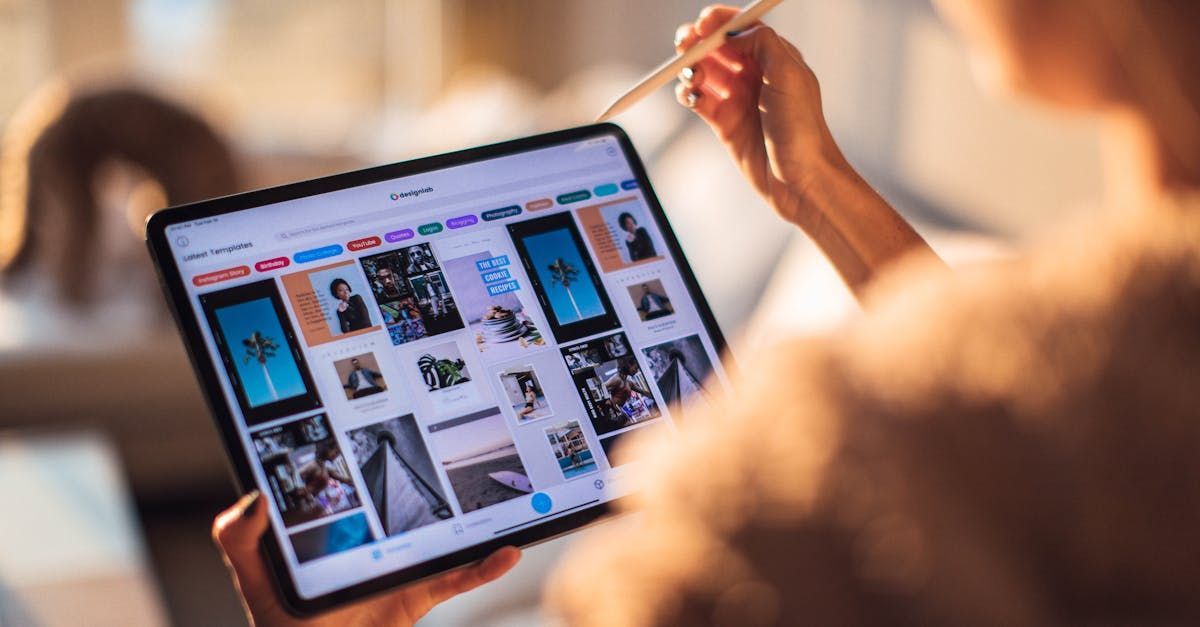 A person is holding a tablet with a pen in their hand.