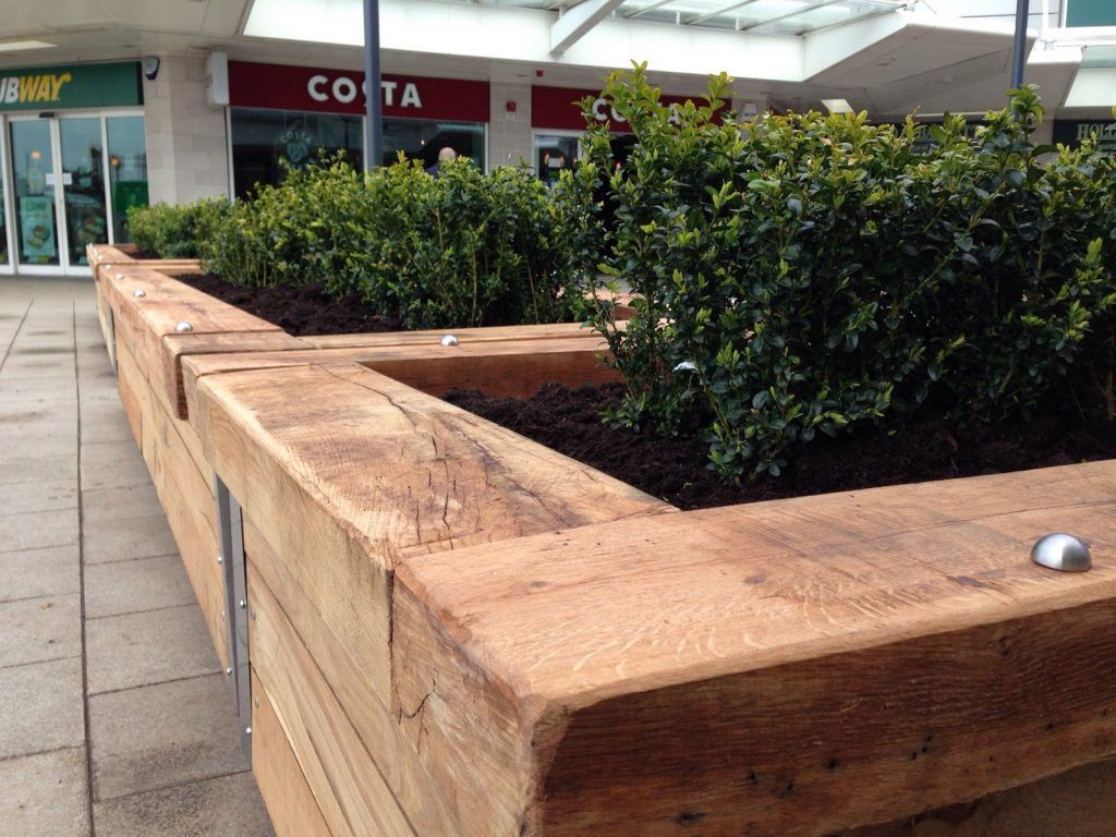 A soft landscaping project in a shopping precinct to include raised sleeper bed planters