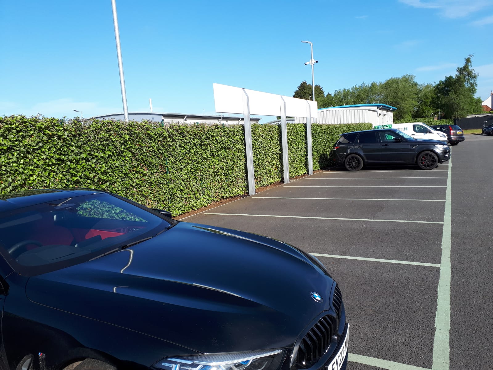 Mobilane green screens installed on powder coated steel posts for a BMW garage in Lincoln