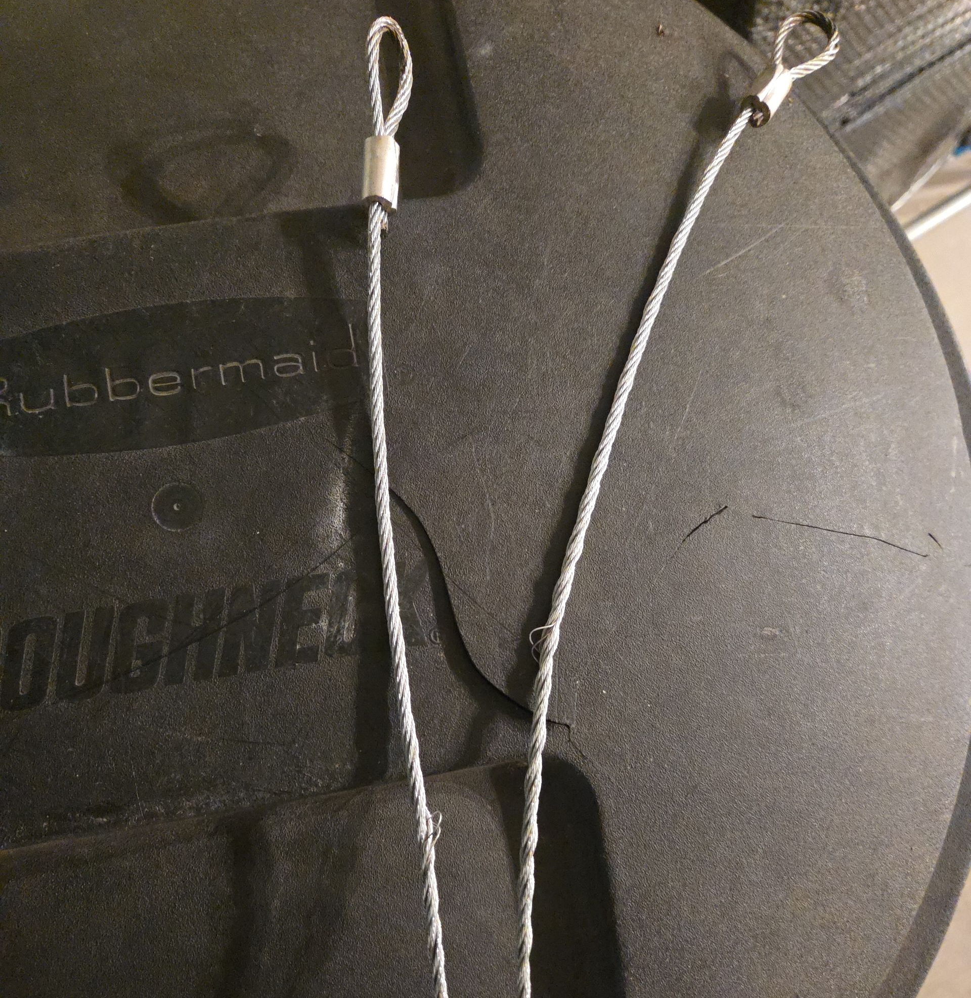 A man is using a drill to install a garage door.