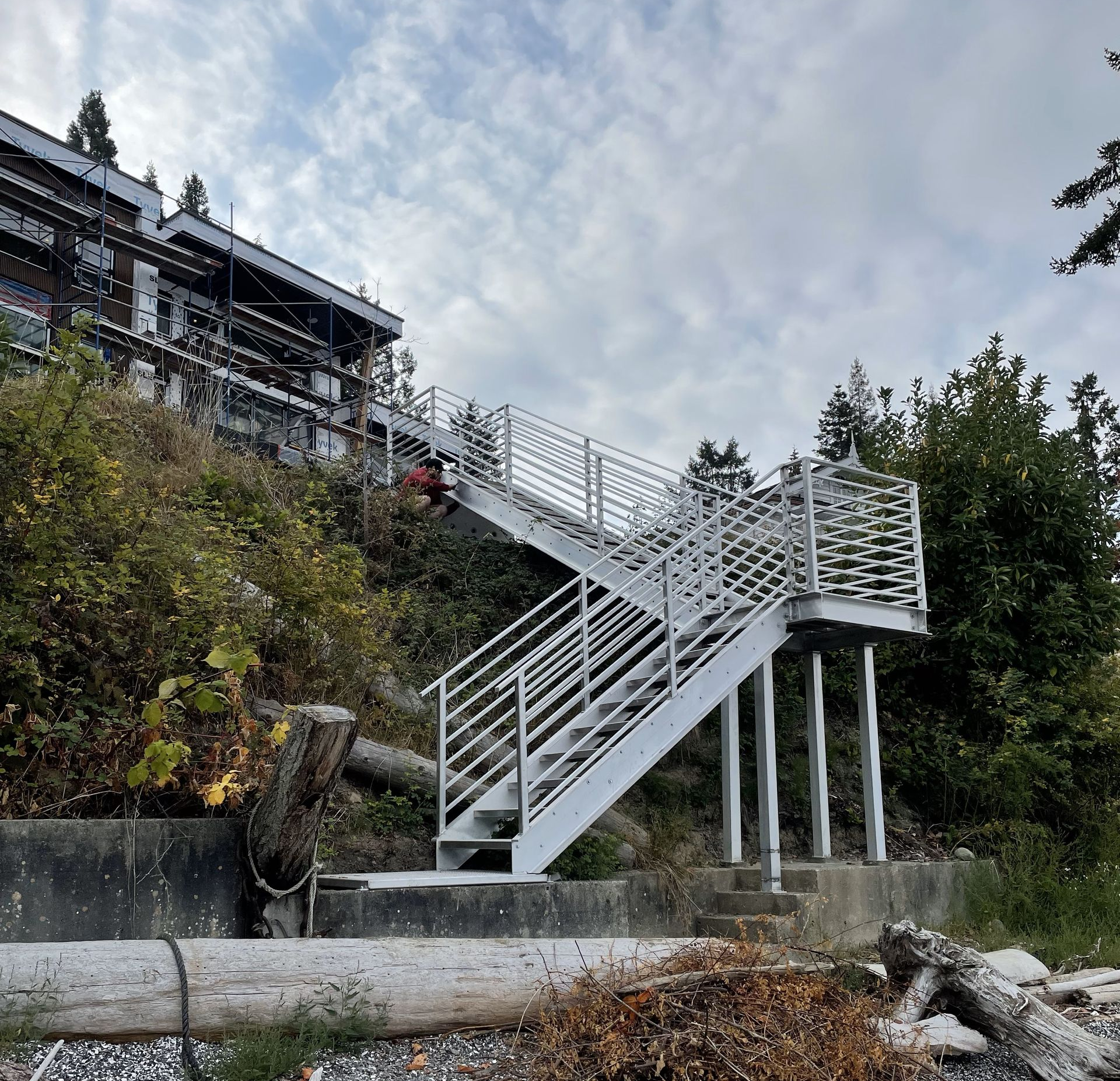 Metal beach access staircase from the house to the beach down a cliffside